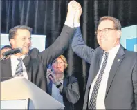  ?? TERESA WRIGHT/THE GUARDIAN ?? Brad Trivers, left, raises James Aylward’s arm in victory Friday night at the PC party leadership convention in Brudenell. Aylward won the leadership vote over Trivers with 1,685 votes to Trivers’ 1,107.