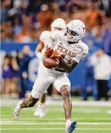  ?? Tim Warner/Getty Images ?? Texas’ Xavier Worthy played much of last season with a broken hand, coach Steve Sarkisian revealed after Monday’s practice.