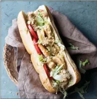  ?? TRIBUNE CONTENT AGENCY ?? Fried shrimp and oysters are the highlight of this Southern-style sandwich.