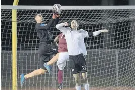  ?? MICHAEL LAUGHLIN/STAFF PHOTOGRAPH­ER ?? Douglas goalie Dillon McCooty catches the ball during the first half of their game on Friday. in front of Pines Charter’s Zeyad Ghali