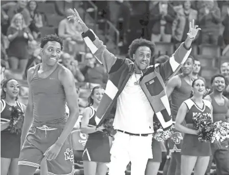  ?? CHRIS DAY/THE COMMERCIAL APPEAL ?? Memphis' Nae'qwan Tomlin, left, and former Memphis player Deandre Williams walk onto the court as Tomlin is honored during a senior day celebratio­n before the againstt UAB at Fedexforum in Memphis on Sunday.