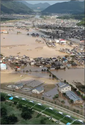  ?? Kyodo News via AP ?? Flooding: This photo shows an submerged housing area in Kurashiki, Okayama prefecture, western Japan Monday. People prepared for risky search and cleanup efforts in southweste­rn Japan on Monday, where several days of heavy rainfall had set off flooding and landslides in a widespread area.