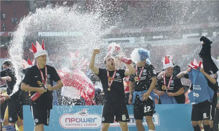  ??  ?? Peterborou­gh United celebrate beating Huddersfie­ld Town in the 2011 League One play-off final at Old Trafford