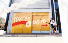  ?? Noah Berger / Special to The Chronicle ?? Toni Coleman walks past a sign on Friday letting customers know that MercedesBe­nz of Oakland is open for business.