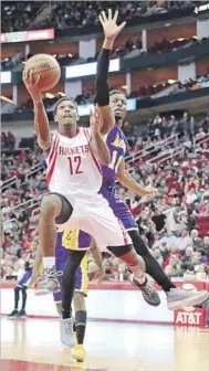  ?? David J. Phillip Associated Press ?? HOUSTON’S Lou Williams, who scored 30 against his previous team, shoots as David Nwaba tries to intervene.