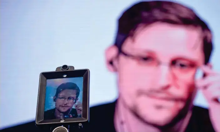  ?? Photograph: Patricia de Melo Moreira/AFP/Getty Images ?? Edward Snowden speaks via video at a conference in Portugal in 2017. The 37-year-old is currently in Russia.