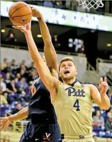  ?? Matt Freed/Post-Gazette photos ?? Ryan Luther battles with Virginia's Devon Hall for the ball in a Jan. 4 game at Petersen Events Center. Luther hasn’t played in five weeks but could return this week, possibly Saturday against North Carolina.