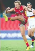  ?? Picture: Jono Searle/AFL Photos ?? LEGWORK: Hugh Greenwood puts the Suns into attack.