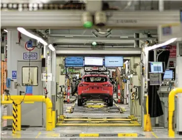  ?? /Bloomberg ?? At a standstill: An automobile on the production line inside the Nissan Motor plant in Sunderland, UK, on July 1 2021. About 900 workers were absent from the plant last week and up to 10% of the workforce is affected at some meat processors.