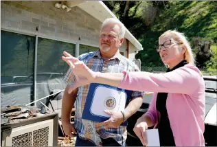  ?? Nikolas Samuels/The Signal (See additional photos at signalscv.com) ?? Michelle Goertz and Clinton “Todd” Smith with the Department of Public Works talk about the fire and flood damage that was done to Goertz’s house in late 2016 and early 2017. Smith was instrument­al in repairing damage the house suffered. The inside of...