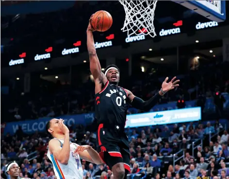  ?? ALONZO ADAMS/USA TODAY SPORTS ?? Raptors guard Terence Davis goes up over Thunder forward Darius Bazley for the bucket during action on Wednesday night at Chesapeake Energy Arena in Oklahoma City. The rookie was one of seven Raptors to hit double digit points in a 130-121 Toronto victory.