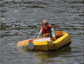  ?? MARIAN DENNIS — MEDIANEWS GROUP ?? A participan­t paddles her way back after racing in a cardboard boat race on the Schuylkill River.