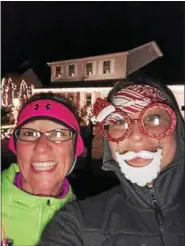  ?? SUBMITTED PHOTO ?? Two participan­ts of a Christmas lights run in Boyertown take a selfie. Some of the runners dressed in holiday outfits for the 5-mile event.