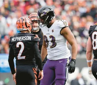  ?? JEFF DEAN/AP ?? Ravens defensive tackle Calais Campbell, center, speaks with Bengals kicker Evan McPherson after McPherson made a field goal during Sunday’s game in Cincinnati.