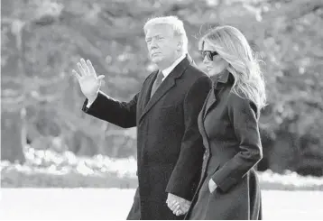  ?? EVANVUCCI/AP ?? President Donald Trump and first lady Melania Trump walk to board Marine One on Wednesday at the White House. A massive coronaviru­s relief and government funding package is in danger after the president slammed it Tuesday night.