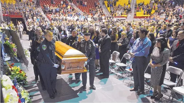  ?? ADOLPHE PIERRE-LOUIS/JOURNAL ?? Pallbearer­s carry Hatch police officer Jose Chavez’s casket during his funeral Sunday at the Pan American Center in Las Cruces. Chavez was shot and killed Aug. 12 during a traffic stop.