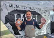  ?? LINNEA COVINGTON — SPECIAL TO THE DENVER POST ?? Longmont farmer-butcher John Scaggs, owner of Lazy J, with a couple of his most popular products at the City Park Farmers Market earlier this month.