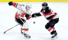  ?? SEAN KILPATRICK/THE CANADIAN PRESS ?? Ottawa Senators defenceman Erik Karlsson defends against Calgary Flames left wing Johnny Gaudreau during third period action, in Ottawa last season.