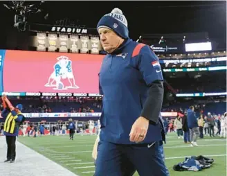  ?? MICHAEL DWYER /AP ?? Patriots coach Bill Belichick walks off the field after the team’s 24-10 loss to the Bills on Dec. 1 in Foxborough, Massachuse­tts.