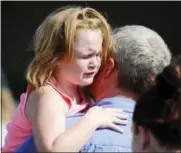  ?? RAINIER EHRHARDT — THE ASSOCIATED PRESS ?? Lilly Chapman, 8, cries after being reunited with her father, John Chapman at Oakdale Baptist Church on Wednesday in Townville, S.C. Students were evacuated to the church following a shooting at Townville Elementary School. A teenager opened fire at a...