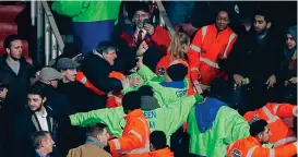  ?? SPORTIMAGE ?? Trouble: stewards step in to prevent fans clashing at the end of the game