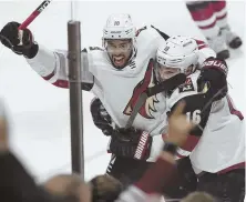  ?? AP PHOTO ?? YAHOO! Arizona’s Anthony Duclair, left, celebrates with teammate Max Domi after his overtime goal yesterday.