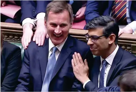  ?? ?? Rishi Sunak congratula­tes the chancellor after delivering yesterday's spring statement to the Commons