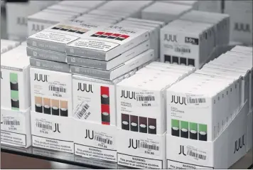  ?? Will Waldron / Times Union ?? JUUL electronic cigarettes are displayed at Exscape Smoke Shop on Friday on Western Avenue in Albany. Some argue these help smokers quit tobacco. Critics aren’t so sure.