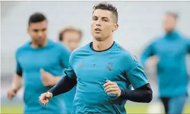  ?? MATTHIAS SCHRADER THE ASSOCIATED PRESS ?? Real Madrid’s Cristiano Ronaldo warms up during a training session in Munich on Tuesday.