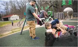  ?? MADDIE MCGARVEY THE NEW YORK TIMES ?? Anna Lara and her partner Jeremy Finley play with their children in Huntington, W.Va. She said the child tax credit allowed the family to replace a dishwasher.