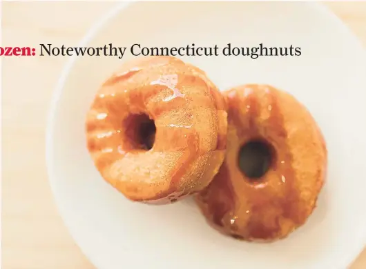  ?? Idlewild Photo Co. ?? Hot sourdough doughnuts at Nana’s Bakery & Pizza in Mystic are fried to order. A caramel sauce gets its advertised umami flavor from koji, a type of mold used to ferment food.