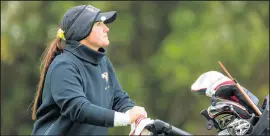  ??  ?? Valparaiso’s Tiffany Curtis pushes her golf cart.