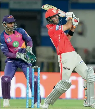  ?? — AFP ?? Glenn Maxwell plays a shot as Rising Pune Supergiant wicketkeep­er MS Dhoni looks on.