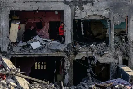  ?? AFP PHOTO ?? THERE’S NO PLACE LIKE HOME
Palestinia­n civilians inspect what is left of a building where two Israeli hostages reportedly had been held before they were rescued during an Israeli operation in the city of Rafah, southern Gaza Strip on Monday, Feb. 12, 2024.