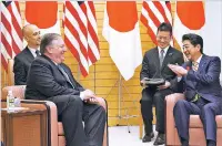  ?? AP PHOTO/EUGENE HOSHIKO, POOL ?? Secretary of State Mike Pompeo, left, and Japanese Prime Minister Shinzo Abe speak in Tokyo on Saturday. Pompeo arrived in Tokyo for talks with Japanese officials ahead of his trip to North Korea.