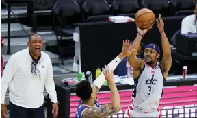  ?? MATT SLOCUM — THE ASSOCIATED PRESS ?? The Wizards’ Bradley Beal, right, puts up a shot against the Sixers’ Danny Green during a first-round basketball playoff series in Philadelph­ia.