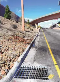  ?? ADOLPHE PIERRE-LOUIS/JOURNAL ?? A New Mexico license plate and oil stain remain at the site of an overnight crash that killed three people. Police say that a suspected drunken driver was traveling on the I-25 north frontage road when he ran a red light and struck a vehicle traveling...