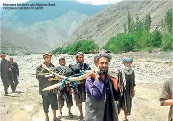  ??  ?? Rescuers battle to aid Afghan flood victims as toll hits 74 (AFP)