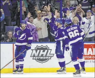  ?? Chris O’Meara The Associated Press ?? Lightning center Brayden Point, left, celebrates with teammates Steven Stamkos and Nikita Kucherov after scoring against the Knights on Tuesday.