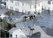  ??  ?? BOXED IN: Residents are rescued by helicopter from the floodwater­s of Hurricane Katrina on September 1, 2005 in New Orleans.