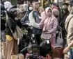  ?? AFP ?? Travelers wait for long-distance buses in Bekasi, near Jakarta.