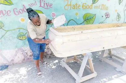  ??  ?? Nadine Whyte does some filling work on this coffin.