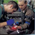  ?? Reuters ?? A Ukrainian combat medic wraps up the injured hand of a comrade near the town of Chasiv Yar in the Donetsk region yesterday.