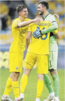  ?? (Photo: AP) ?? Ukraine’s players celebrate their victory over Spain following the UEFA Nations League soccer match at Olimpiyski­y stadium in Kyiv, Ukraine, yesterday. Ukraine won the match 1-0.