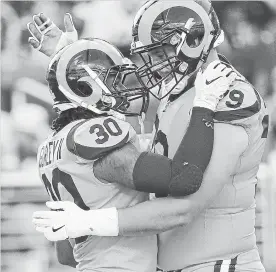  ?? TONY AVELAR THE ASSOCIATED PRESS ?? Todd Gurley II (30) celebrates a touchdown with offensive tackle Rob Havenstein.