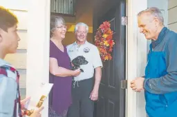  ??  ?? Broomfield residents Janet and Rick Beaver, center, greet Eric Rutherford and Rutherford’s son, Kai, as they go door to door to discuss Eric’s support of Propositio­n 112.