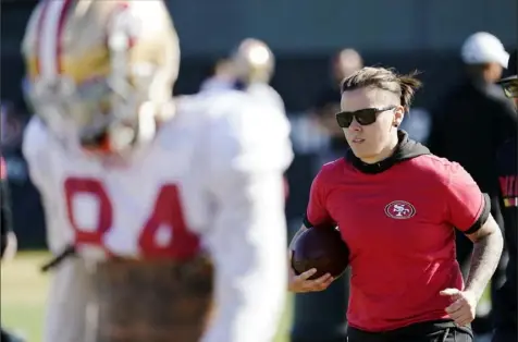  ?? Associated Press ?? Katie Sowers, right, runs a drill in one of the 49ers pre-Super Bowl practices last week. Sowers is the first woman to be on a Super Bowl coaching staff. Says Sowers — “Even though I’m the first, the most important thing is I’m not the last.”