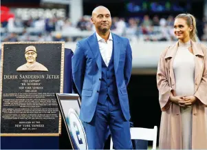  ?? (Reuters) ?? FORMER NEW YORK YANKEES shortstop Derek Jeter and his wife Hannah look on during an emotional ceremony at Yankee Stadium on Sunday night to retire his jersey number and unveil his monument that will be placed in Monument Park.