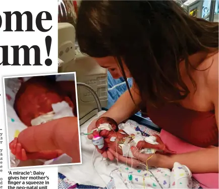  ??  ?? ‘A miracle’: Daisy gives her mother’s finger a squeeze in the neo-natal unit