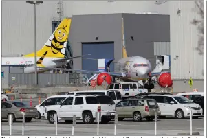  ?? (AP/Ted S. Warren) ?? Airplanes and a handful of vehicles are parked Monday at Boeing’s assembly facility in Renton,
Wash.